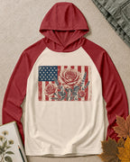 Women's red cream sun hoodie with roses and an American flag, front view.