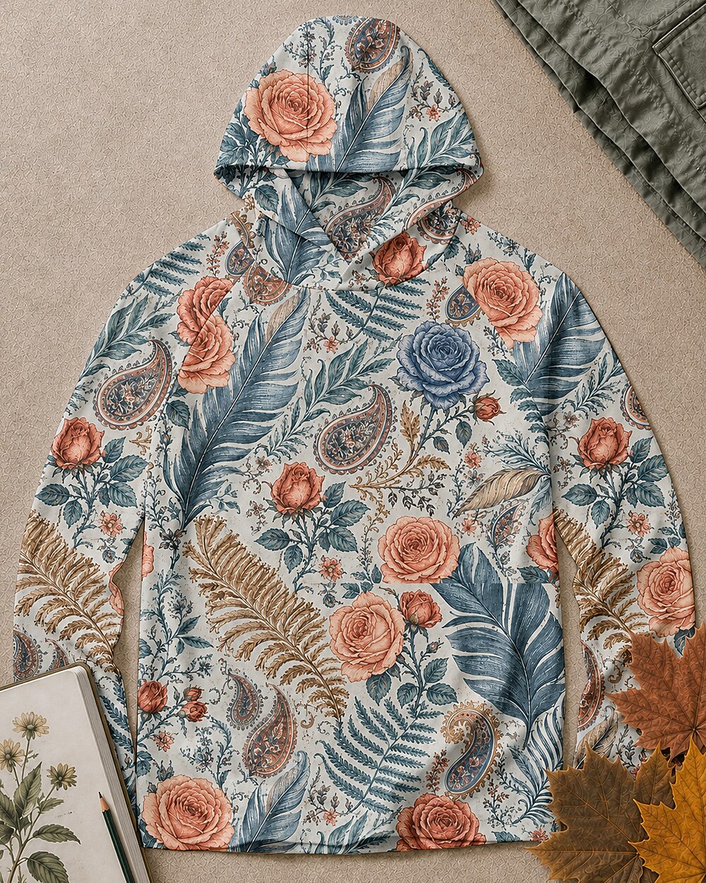 Women's blue sun hoodie with an all-over rose and paisley pattern, front view.