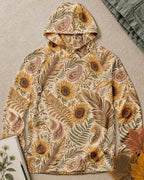 Women's yellow sun hoodie with an all-over sunflower and paisley pattern, front view.
