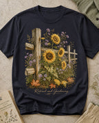 Women's dark navy cotton T-shirt with sunflowers beside a rustic wooden fence, front view.