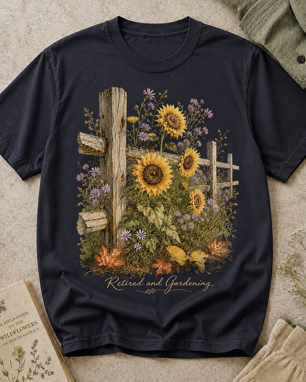 Women's dark navy cotton T-shirt with sunflowers beside a rustic wooden fence, front view.