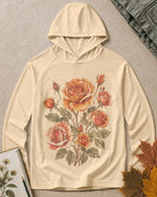 Women's light yellow sun hoodie with vintage roses and leafy stems, front view.