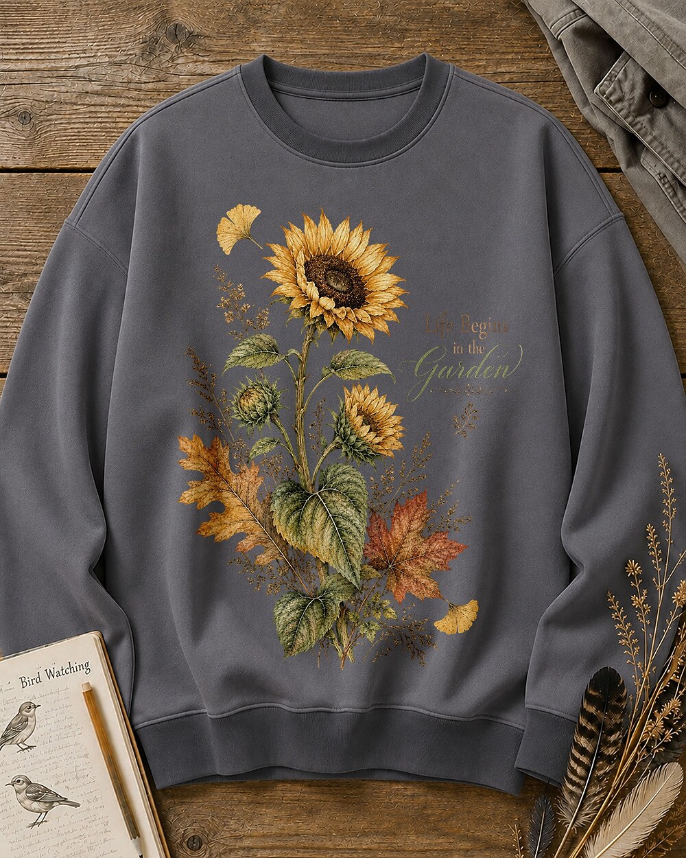Women's gray crewneck sweatshirt with vintage sunflowers and autumn leaves, front view.